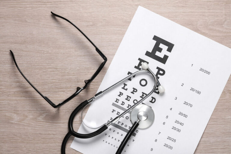 Glasses and eye chart with stethoscope – illustrating vision diagnosis and correction for lazy eye and keratoconus