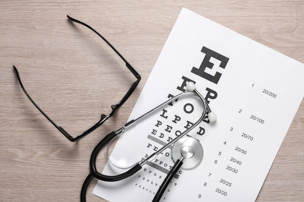 Glasses and eye chart with stethoscope – illustrating vision diagnosis and correction for lazy eye and keratoconus